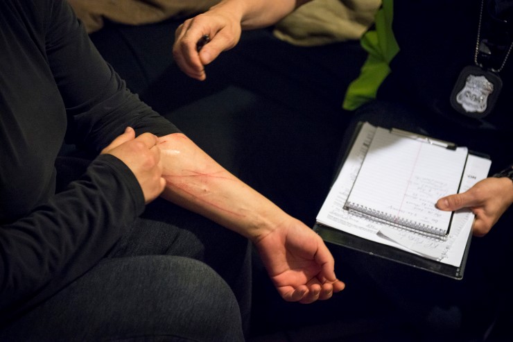  Officer Ernie Stevens looks as a woman reveals the marks where she cut herself, in her home in San Antonio, Texas. Stevens sat and spoke with the woman about what had motivated her to injure herself and her possible suicidal thoughts before asking the woman if she wanted to receive further treatment at a mental-health facility built to temporarily treat the mentally ill outside of jail and outside of the ER. MATTHEW BUSCH