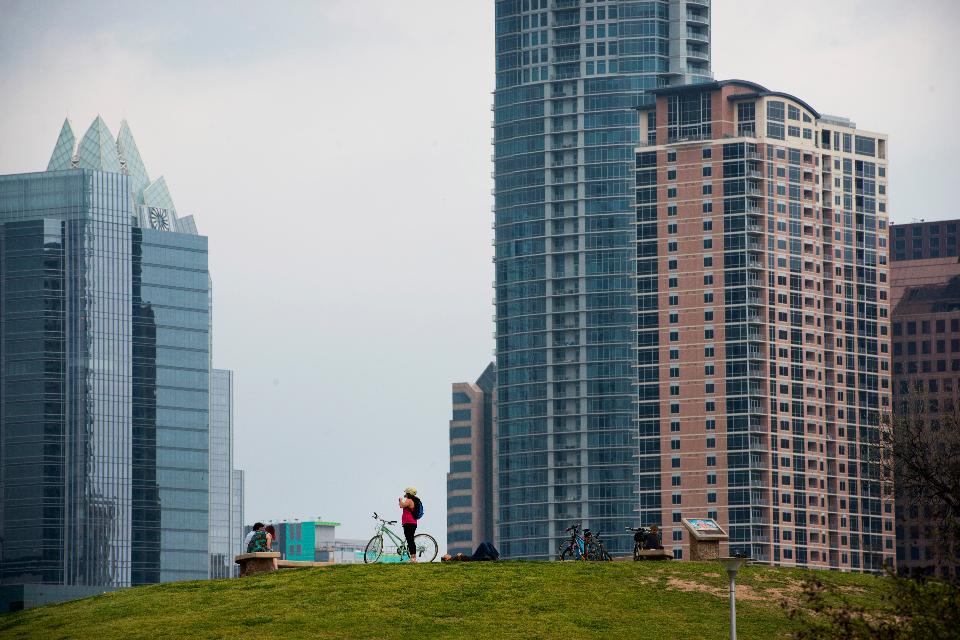 Bicyclists take a break below new buildings in Austin, Texas, on April 3, 2015. About 900,000 people live in Austin and the city expects that number to reach nearly 1.3 million by 2040. Austin and San Antonio are the twin anchors of a region that is experiencing the fastest growth in the United States. (Matthew Busch/Bloomberg)