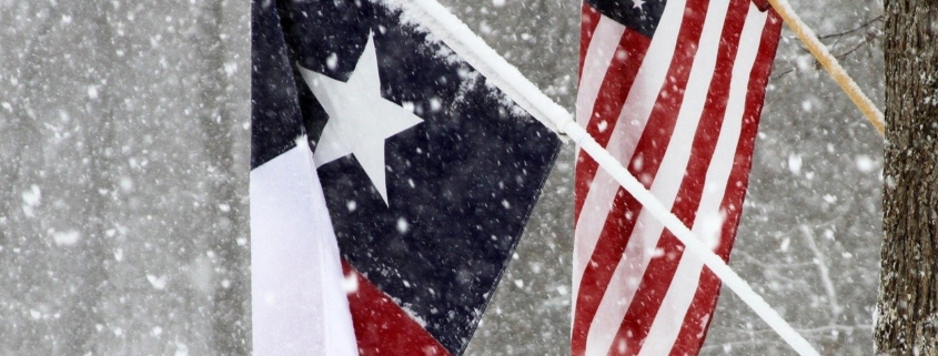 Texas and USA flags in snow